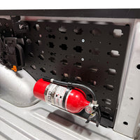 Fire Extinguisher Mount, mounted horizontally on a MOBUL panel in a truck bed.