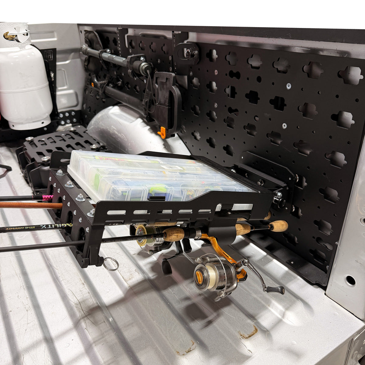 MOBUL Fishing Rod Holder, with tackle tray and reels on a MOBUL panel in a truck bed.